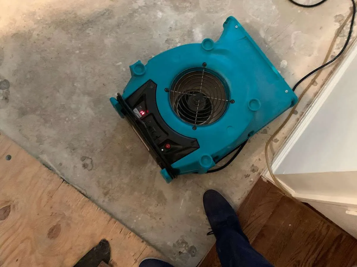 Air mover drying subfloor during Commercial Water Damage Restoration in Elburn